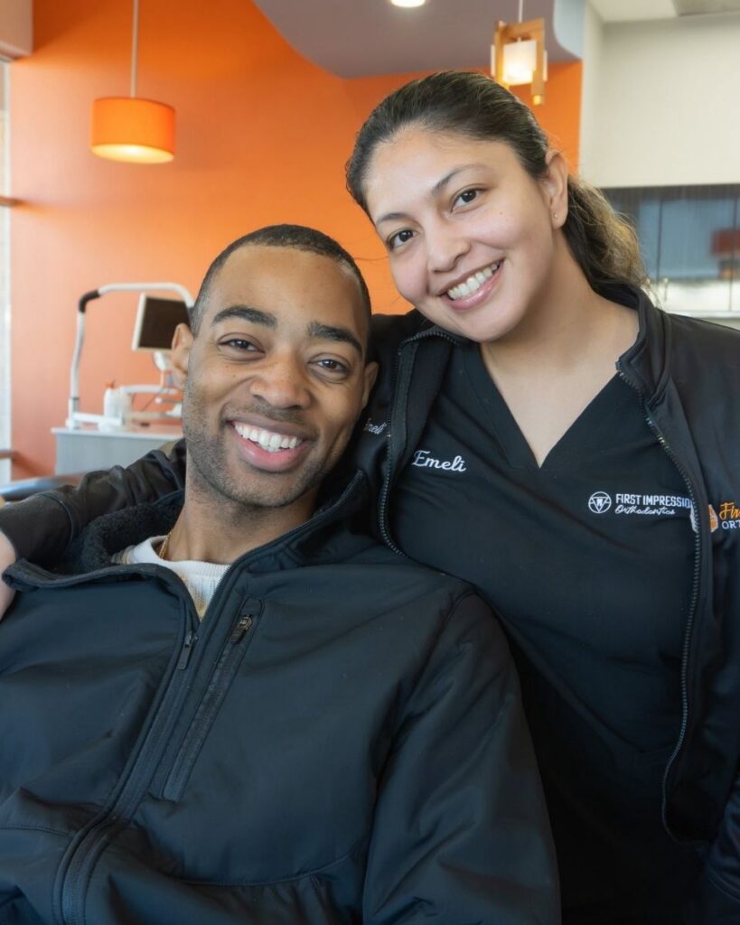 Team member and patient smiling in exam chair, First Impression Orthodontics in Alexandria VA